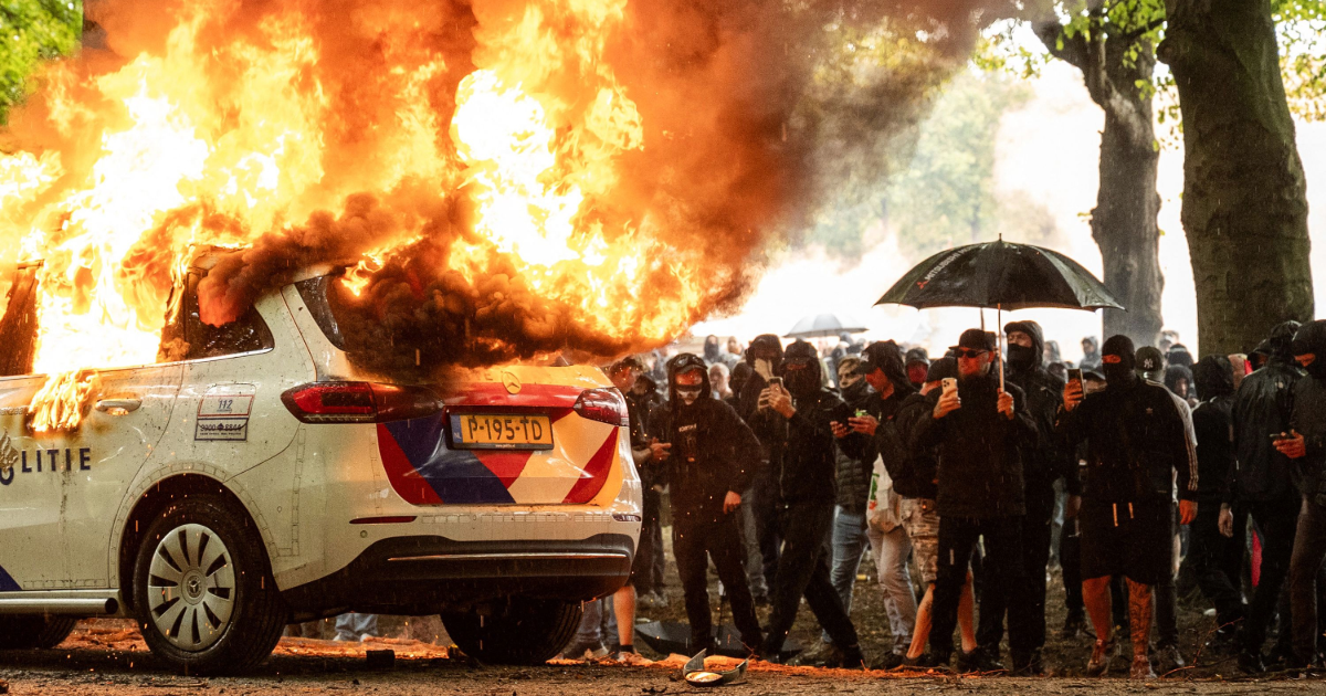 A police car is set on fire during the "Stand up for the Netherlands" demonstration against the government's current asylum seekers policy, in The Hague, on Saturday. Josh Walet/ANP/AFP/Getty Images