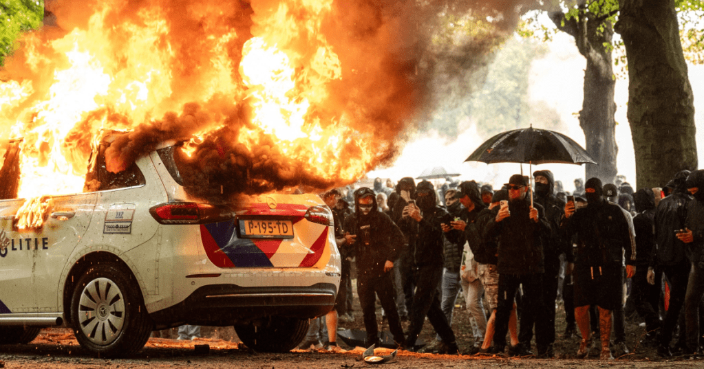 A police car is set on fire during the "Stand up for the Netherlands" demonstration against the government's current asylum seekers policy, in The Hague, on Saturday. Josh Walet/ANP/AFP/Getty Images