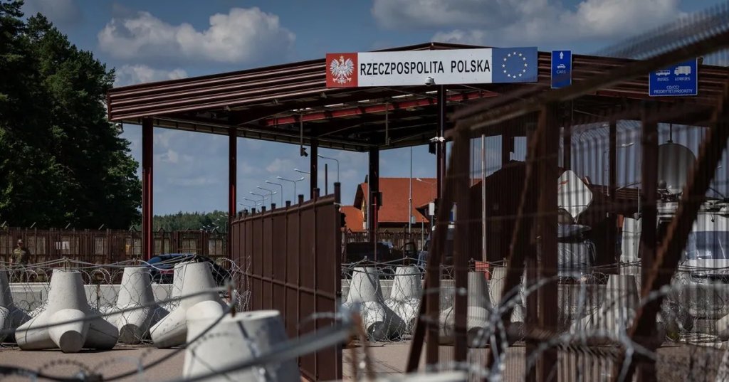 A sign reads "Republic of Poland" at the border crossing of the Polish-Belarusian country border with barbed wire and a fence in Polowce-Pieszczatka, Poland on July 21.Photographer: Wojtek Radwanski/AFP/Getty Images