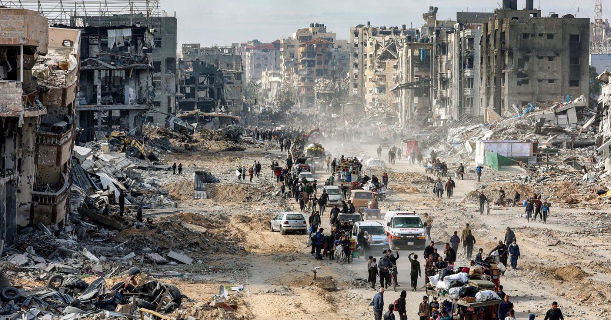 People walk past the rubble of collapsed buildings along Saftawi street in Jabalia in the northern Gaza Strip on January 20, 2025, a day after a short-lived ceasefire went into effect. Omar Al-Qattaa/AFP/Getty Images