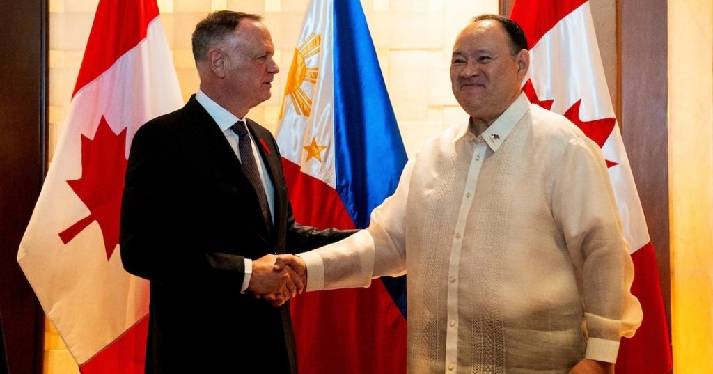 Canada's Defence Minister David McGuinty and his Philippine counterpart Gilberto Teodoro Jr shake hands before their bilateral meeting in Makati City, Metro Manila, Philippines, November 2, 2025. REUTERS/Lisa Marie David