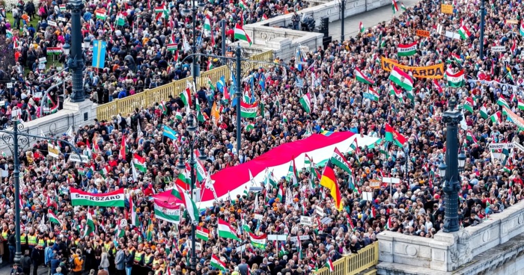 Participants of the Peace March organized by the pro-government Civil Unity Forum (COF) and its foundation Civil Unity Public Benefit Foundation (COKA) gather at the Buda side of Margaret Bridge in Budapest, Hungary, Thursday, Oct. 23, 2025, (Zsolt Czegledi/MTI via AP)