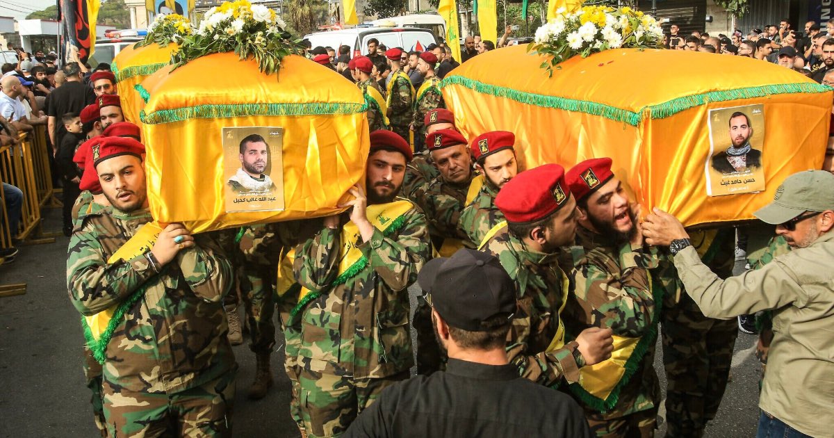 Hezbollah members carry the coffins of comrades killed in recent Israeli attacks during their funeral in the southern city of Nabatieh on November 2, 2025. (MAHMOUD ZAYYAT / AFP)