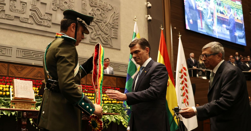 President Rodrigo Paz, right, receives the presidential sash from Vice President Edman Lara in La Paz, Bolivia, Saturday, Nov. 8, 2025. (Luis Gandarillas, Pool Photo via AP)