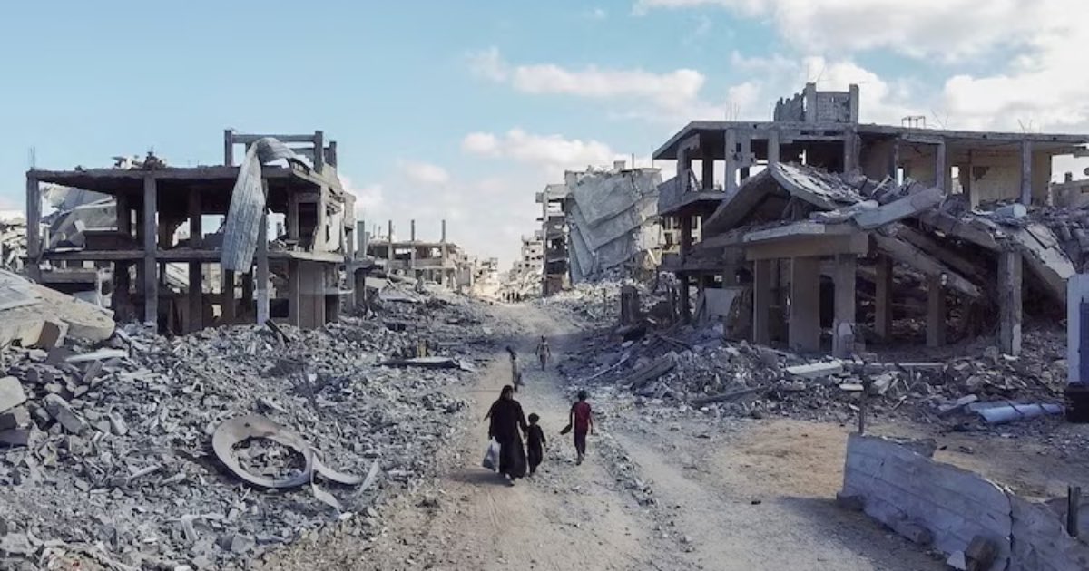 A drone view shows people walking through a destroyed residential neighbourhood, following the withdrawal of the Israeli forces from the area, amid a ceasefire between Israel and Hamas in Gaza, in Gaza City, Oct. 18, 2025. Dawoud Abu Alkas Reuters