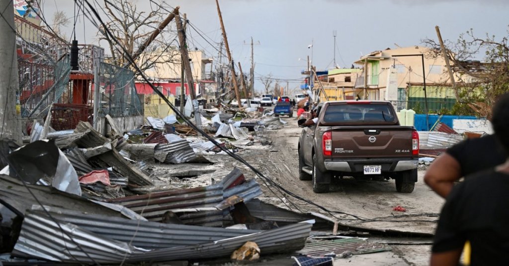 A car drives through the a destroyed neighborood following the passage of Hurricane Melissa, in Black River, Jamaica on October 29, 2025. Ricardo Makyn/AFP via Getty Images