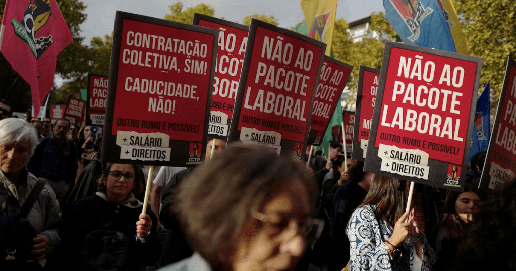 People hold placards during a demonstration held by the General Confederation of the Portuguese Workers (CGTP) demanding better wages and working conditions, in Lisbon, Portugal, November 8, 2025.REUTERS/Pedro Nunes