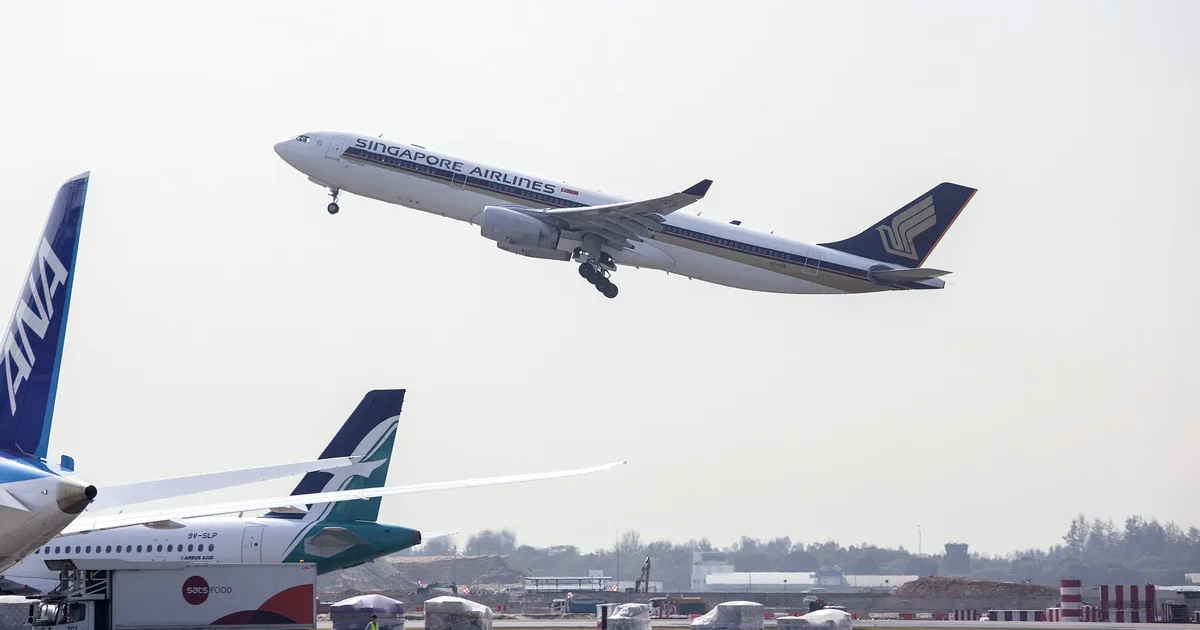 Aircraft take off from Changi Airport in Singapore.Photographer: Ore Huiying.Bloomberg
