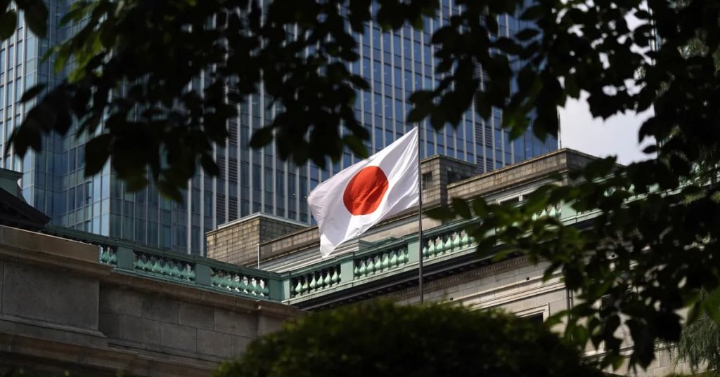 A Japanese national flag flies outside the Bank of Japan headquarters in Tokyo. Photographer: Toru Hanai/Bloomberg