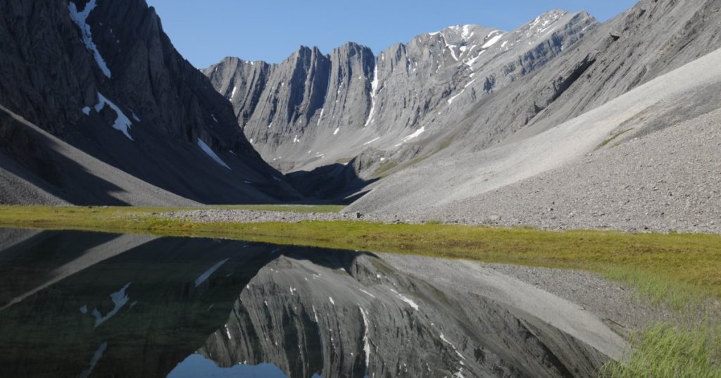 In this July 30, 2014 photo provided by the National Park Service is a small tarn in a hidden valley in the Itkillik Preserve at the Arctic National Park and Preserve in Alaska. The nation’s northernmost national park says its new management plan will have to consider the effects of a new industrial road to the mining district of Ambler, the first road that would be constructed within its Maryland-sized boundaries. (AP Photo/National Park Service, Cadence Cook)
