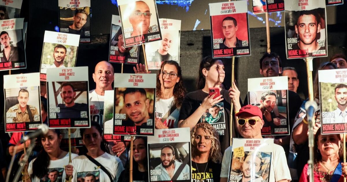 People hold placards with pictures of hostages who were kidnapped in the deadly October 7, 2023 attack by Hamas, after a ceasefire between Israel and Hamas in Gaza went into effect, in Tel Aviv, Israel, October 11, 2025. - tut0ugh via Declan Herald