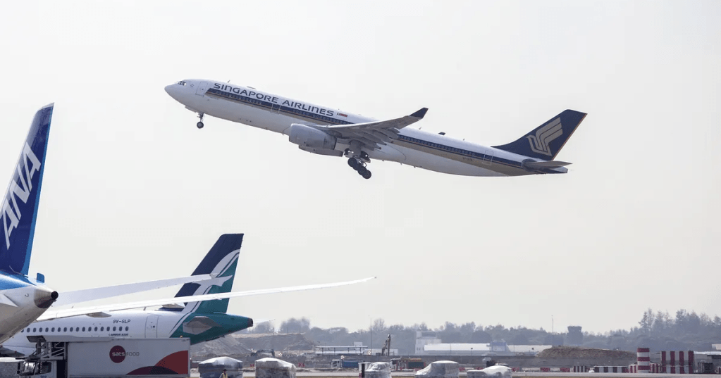 Aircraft take off from Changi Airport in Singapore.Photographer: Ore Huiying.Bloomberg