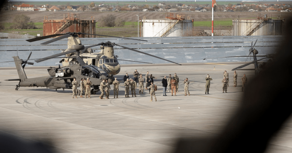 U.S. Army troops near a CH-47 Chinook and a AH-64E attack helicopter at MK Airbase, in Mihail Kogalniceanu, Constanta county, Romania, November 25, 2025. Inquam Photos/George Calin via REUTERS