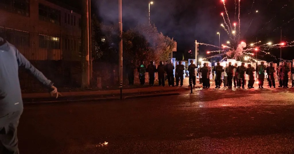 A protester hurls a firework toward police officers on Oct. 21, 2025 in Dublin, Ireland. Natalia Campos - Getty Images