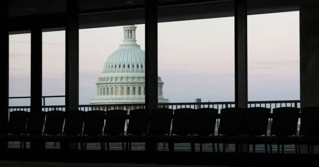 Dawn brightens the sky over the U.S. Capitol dome, seen from an empty meeting room during the continuing partial federal government shutdown in the Hart Senate Office Building on Capitol Hill in Washington, D.C., U.S., October 7, 2025. REUTERS/Jonathan Ernst