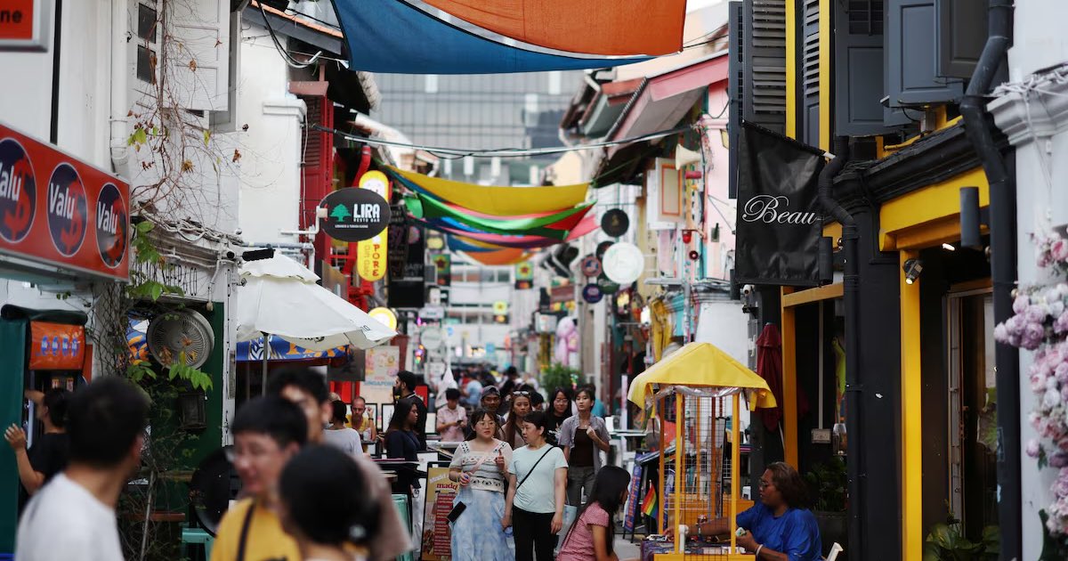 People walk through a shopping street at Kampong Glam district in Singapore June 11, 2025. REUTERS/Edgar Su
