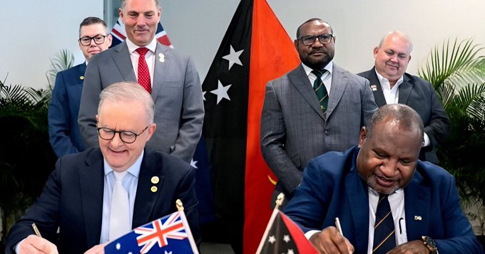 Papua New Guinea's Prime Minister James Marape, right, and his Australian counterpart Anthony Albanese, left, sign a mutual communique in Port Moresby on September 17, 2025