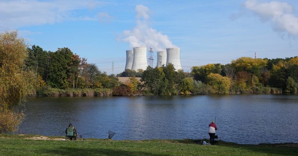 People fish near the towering Dukovany nuclear power plant, background, in Dukovany, Czech Republic. - Copyright AP Photo/Petr David Josek