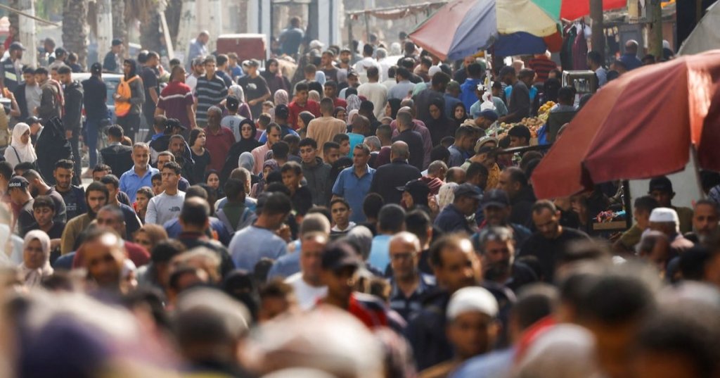 People gather and shop at a local market, in Nuseirat, central Gaza Strip, November 13, 2025. REUTERS/Mahmoud Issa