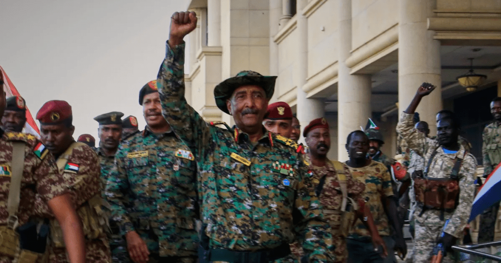 Sudan’s military chief Gen. Abdel-Fattah Burhan, center, is greeted by troops as he arrives at the Republican Palace, recently recaptured from the Rapid Support Forces (RSF) paramilitary group, in Khartoum, Sudan, March 26, 2025. (AP Photo/File)