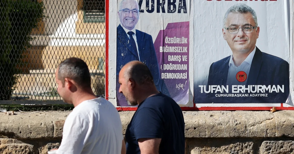 People walk past a campaign poster of Turkish Cypriot candidate Tufan Erhurman, in the divided city of Nicosia, Cyprus, October 18, 2025 (credit REUTERS-YIANNIS KOURTOGLOU)