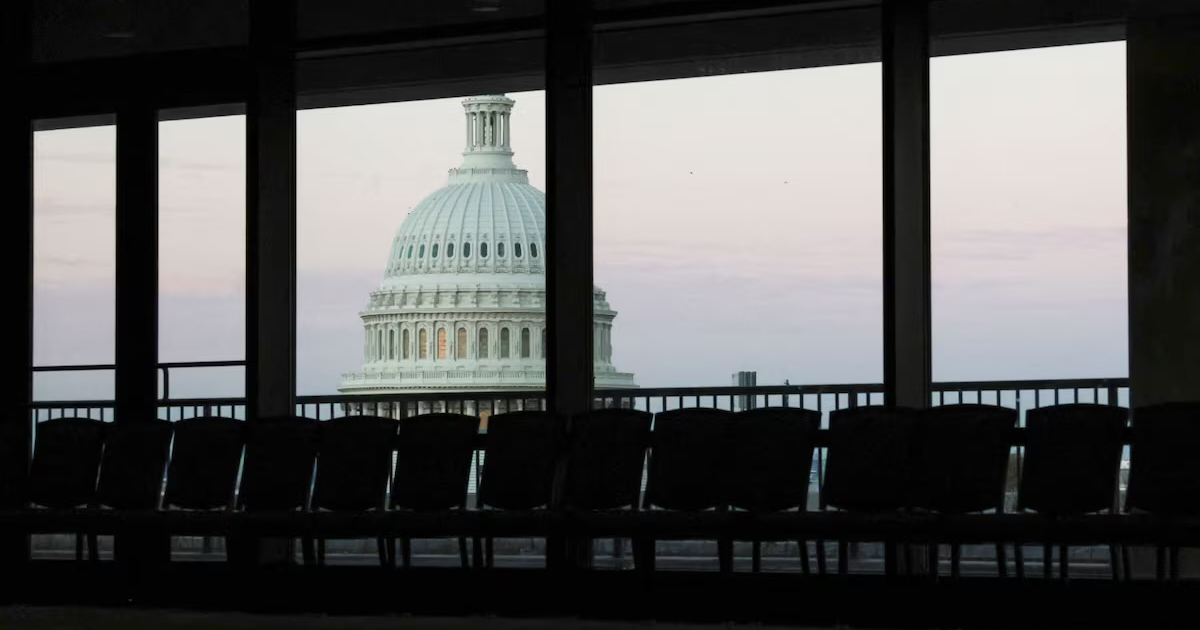 Dawn brightens the sky over the U.S. Capitol dome, seen from an empty meeting room during the continuing partial federal government shutdown in the Hart Senate Office Building on Capitol Hill in Washington, D.C., U.S., October 7, 2025. REUTERS/Jonathan Ernst