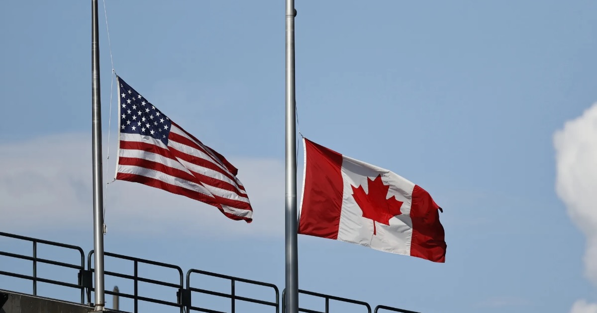 US and Canada flags. Photographer-Steph Chambers..Getty Images