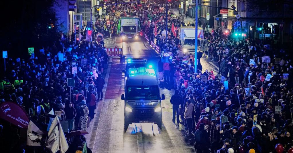 People demonstrate against the planned re-founding of the AfD youth organization in Giessen, Germany, early Saturday, Nov. 29, 2025. (AP Photo/Martin Meissner)