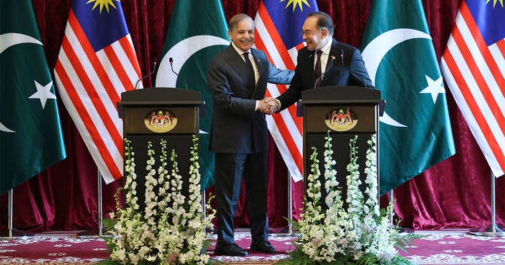 Pakistan's Prime Minister Shehbaz Sharif, left, and Malaysia's Prime Minister Anwar Ibrahim shake hands as they hold a news conference during Sharif's visit in Putrajaya, Malaysia, on October 6, 2025. (AP)