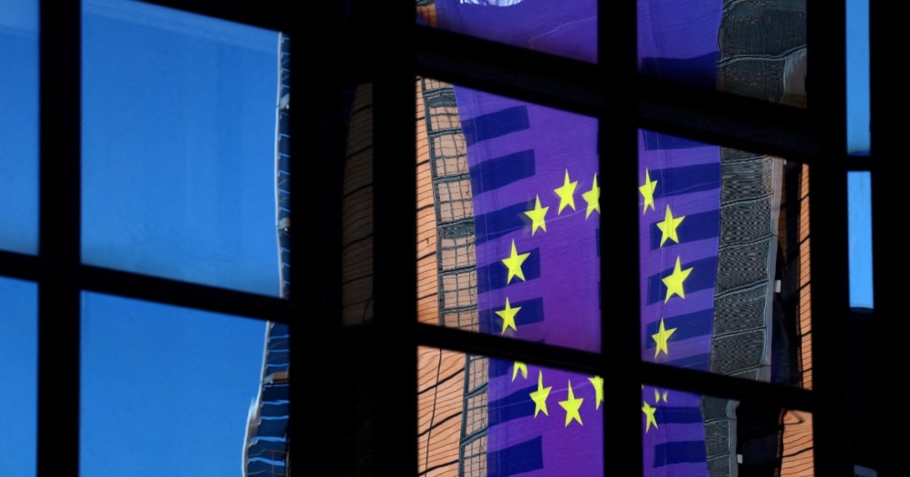A banner depicting an European Union flag is reflected in a window outside the EU Council headquarters in Brussels, Belgium March 18, 2025. REUTERS/Yves Herman//File Photo