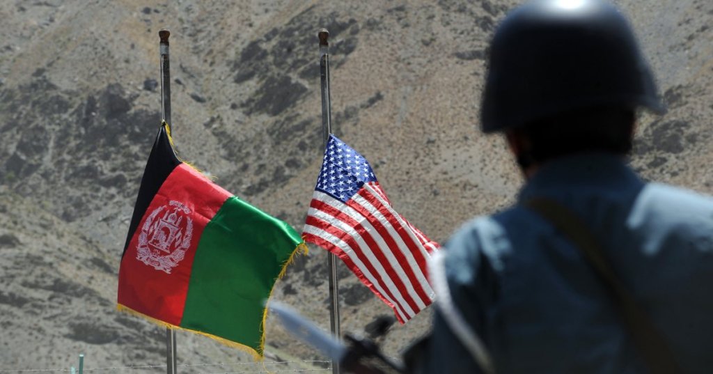 In this file photo taken on July 24, 2011 Afghan and US flags are raised as a policeman keeps watch during a ceremony to hand over security control in the rugged mountains of the Panjshir valley. (AFP Photo)