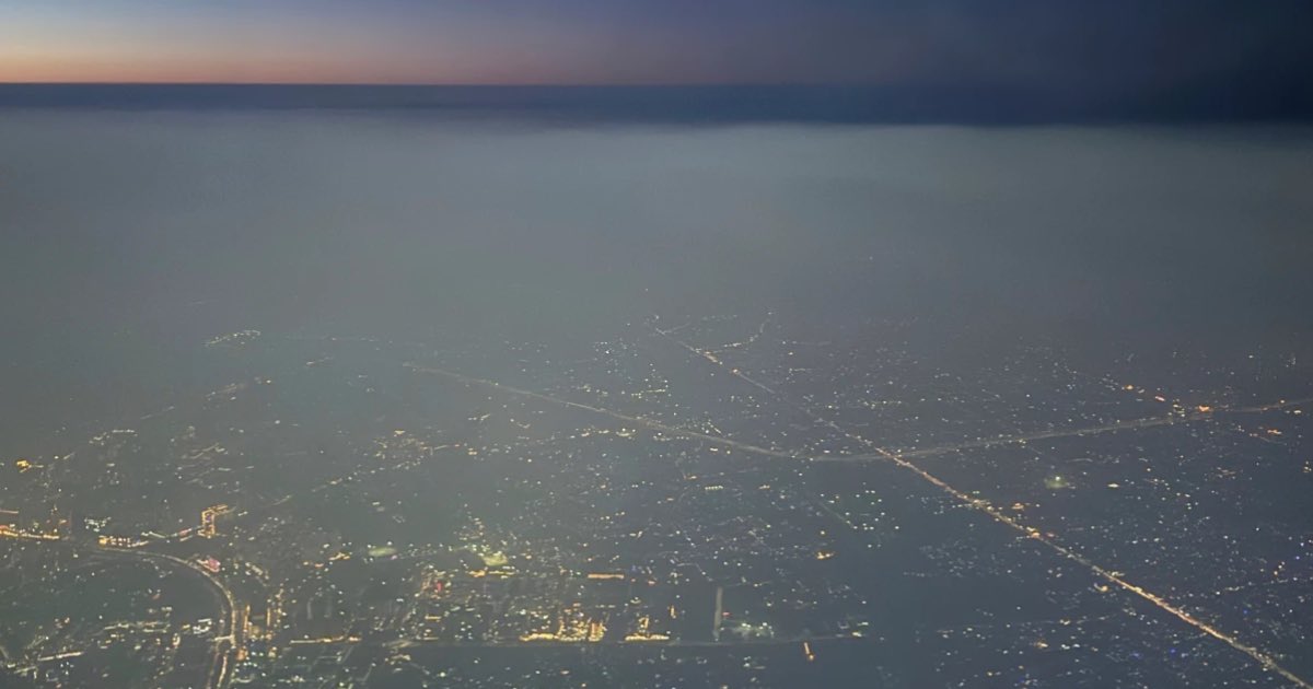 A layer of smog hangs over the skyline as seen from an aircraft window in New Delhi, India, Saturday, Oct. 25, 2025. (AP Photo.Yirmiyan Arthur)