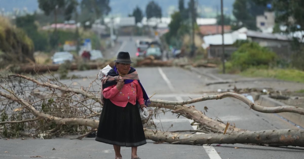 An Indigenous woman traverses roadblocks placed by demonstrators protesting the elimination of the diesel subsidy by President Daniel Noboa's, government in Cayambe, Ecuador, Sunday, Oct. 5, 2025. (AP Photo/Dolores Ochoa)