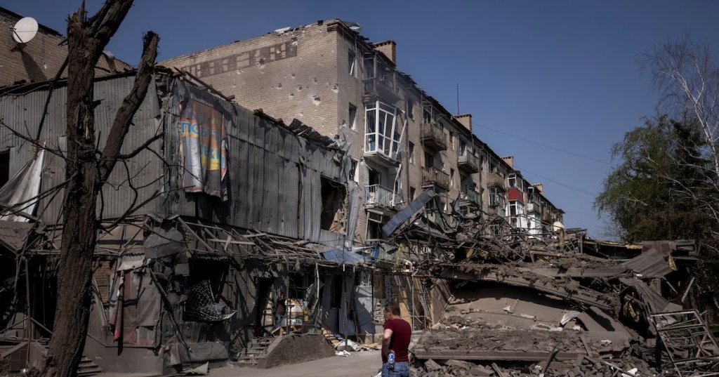 A man looks at damage from shelling opposite the train station in Kostiantynivka. REUTERS/Thomas Peter/File Photo