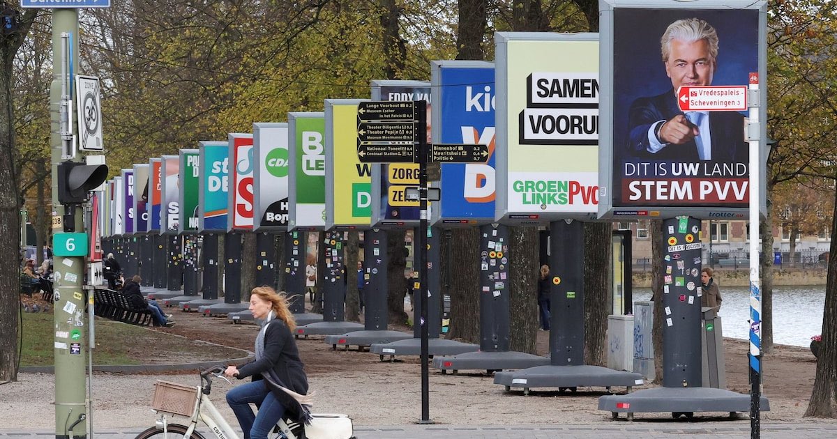 A person rides a bicycle next to election campaign posters on the eve of the Dutch parliamentary election, in The Hague, Netherlands, October 28, 2025. REUTERS/Yves Herman