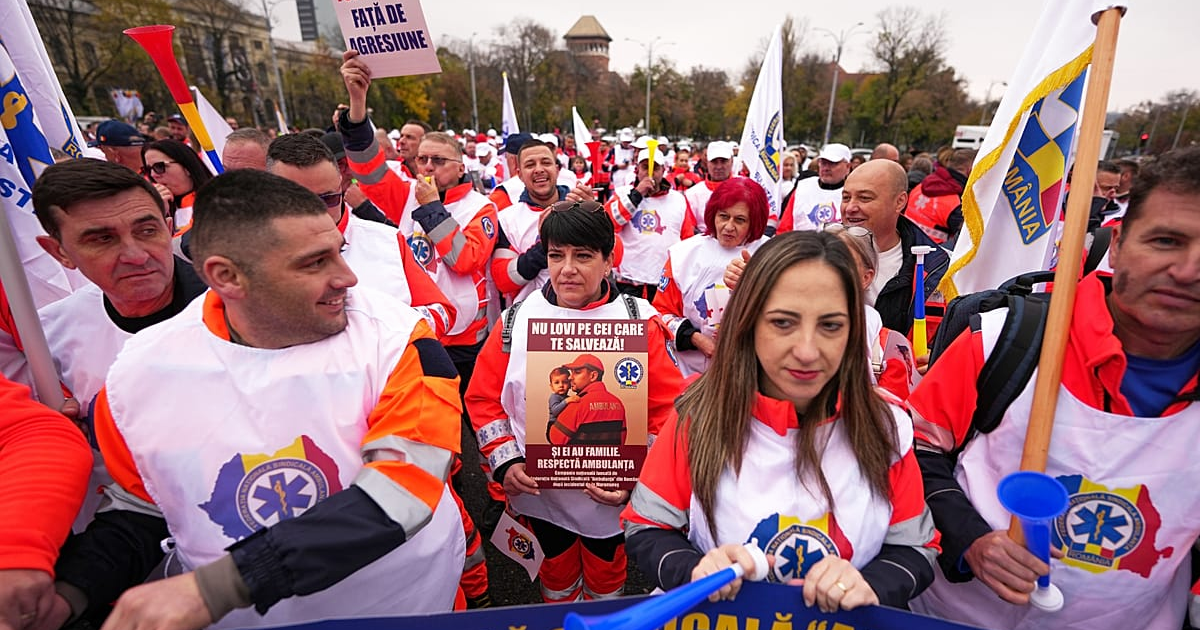 A woman holds a banner that reads "Don't hit the ones who save you" as trade union members protest against austerity measures in Bucharest, 12 November, 2025 AP Photo