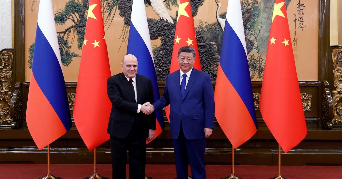 Russian Prime Minister Mikhail Mishustin shakes hands with Chinese President Xi Jinping during a meeting at the Great Hall of the People in Beijing, China, November 4, 2025. Sputnik/Dmitry Astakhov/Pool via REUTERS