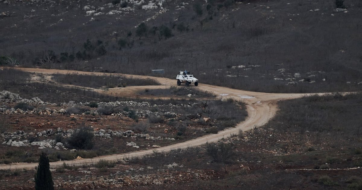 A UN vehicle drives near a concrete wall along Lebanon's southern border which, according to the Lebanese presidency, extends beyond the "Blue Line", a U.N.-mapped line separating Lebanon from Israel and the Israeli-occupied Golan Heights, as seen from northern Israel, November 16, 2025. REUTERS/Shir Torem