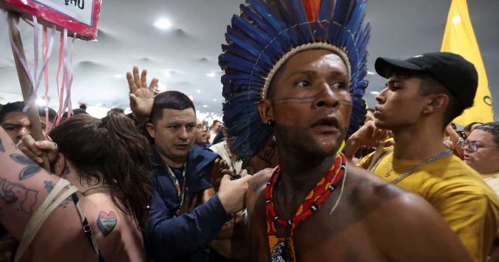An Indigenous demonstrator looks on as protesters force their way into the venue hosting the UN Climate Change Conference (COP30), in Belem, Brazil, November 11, 2025. REUTERS/Anderson Coelho