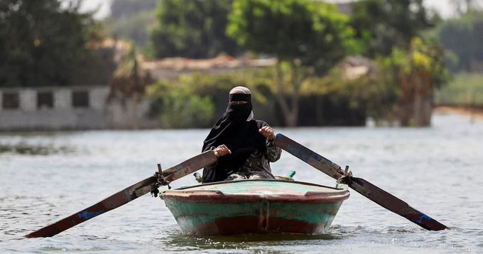 A woman rows her boat after flooding in Dalhamo Village, near the Delta city of Ashmoun, in Menoufia Governorate, Egypt, October 5, 2025. REUTERS/Mohamed Abd El Ghany